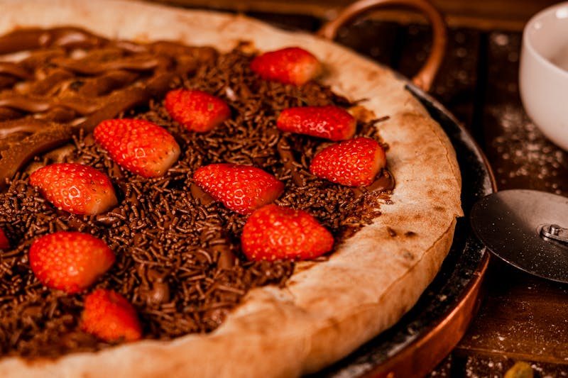 Nutella dessert pizza with strawberries and powdered sugar