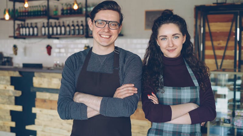Friendly service team members smiling at Dewey's pizza restaurant