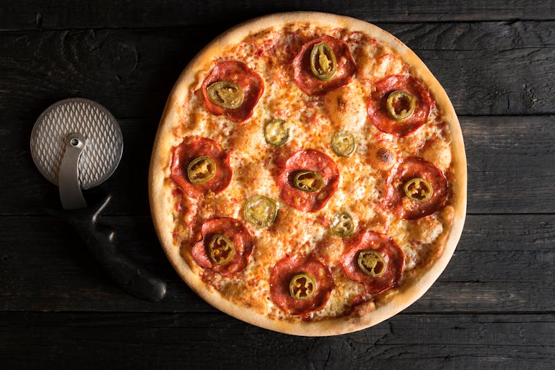 Colorful vegetable pizza with roasted peppers and mushrooms